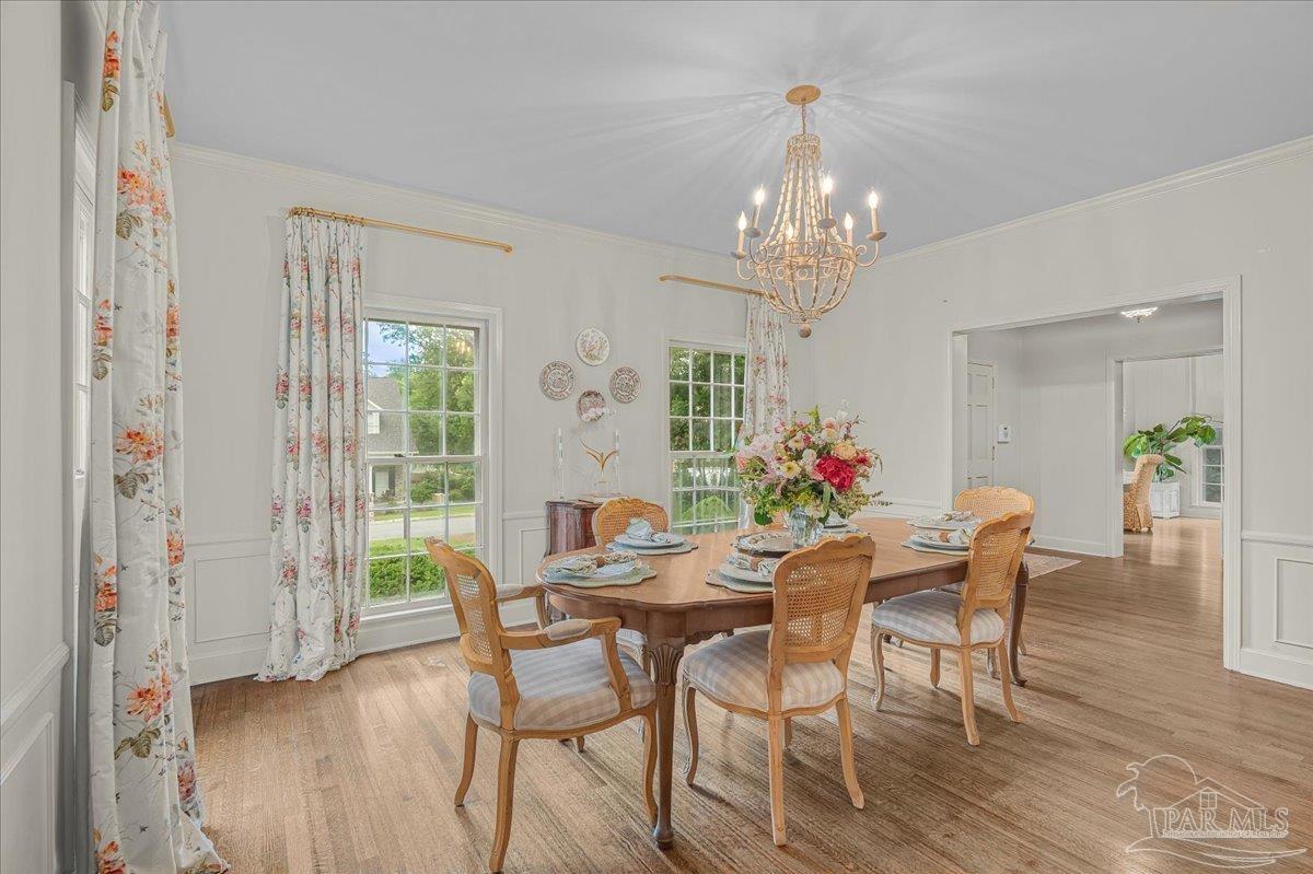 3361 Palermo Road Pensacola, FL 32503 - Photo 26 of 50 a view of a dining room with furniture a chandelier and wooden floor