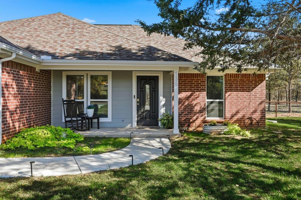 138 Gobbler Road Nocona, TX 76255 - Photo 13 of 35 a front view of a house with garden