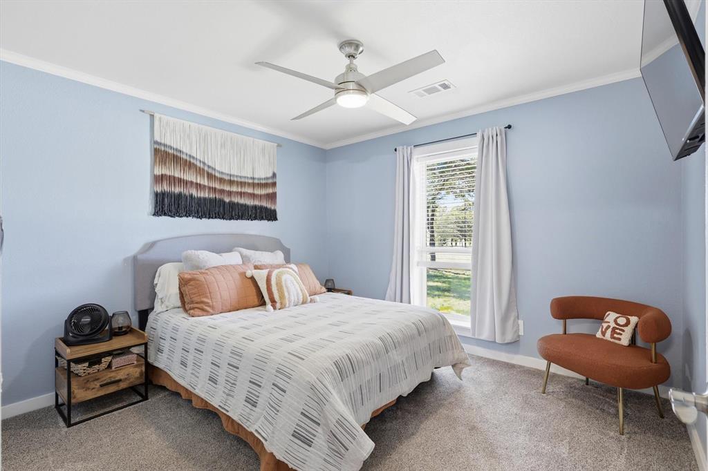 138 Gobbler Road Nocona, TX 76255 - Photo 22 of 35 a bedroom with a bed and a chair