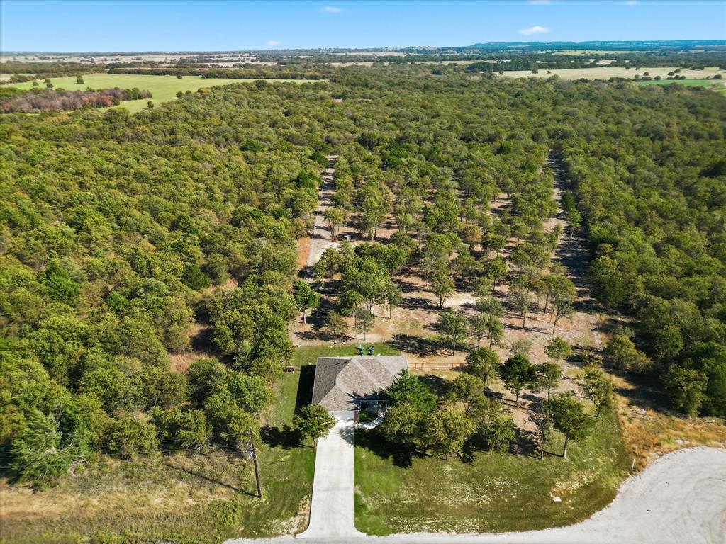138 Gobbler Road Nocona, TX 76255 - Photo 30 of 35 an aerial view of residential houses with outdoor space and trees