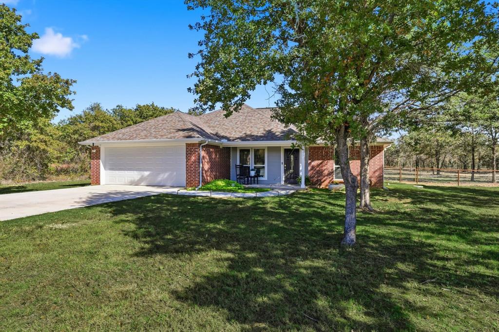 138 Gobbler Road Nocona, TX 76255 - Photo 10 of 35 a front view of a house with a garden