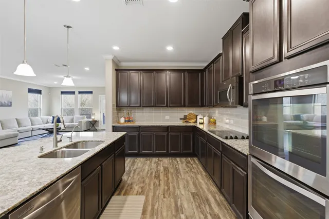 a kitchen with a sink stove top oven and cabinets