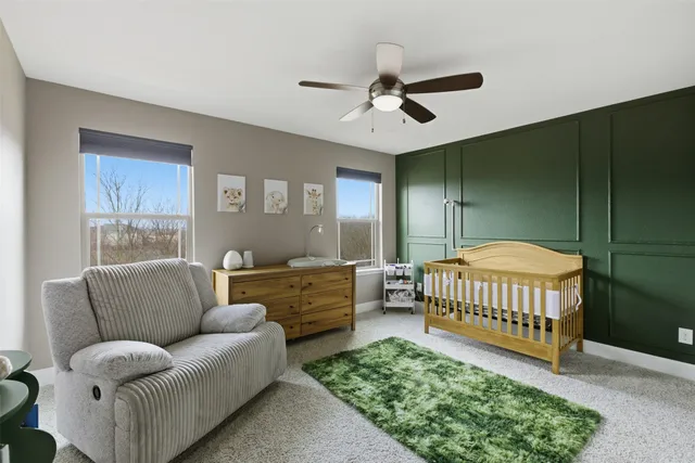 a living room with furniture ceiling fan and a rug