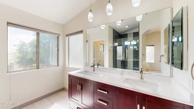 a bathroom with a sink double vanity and a mirror