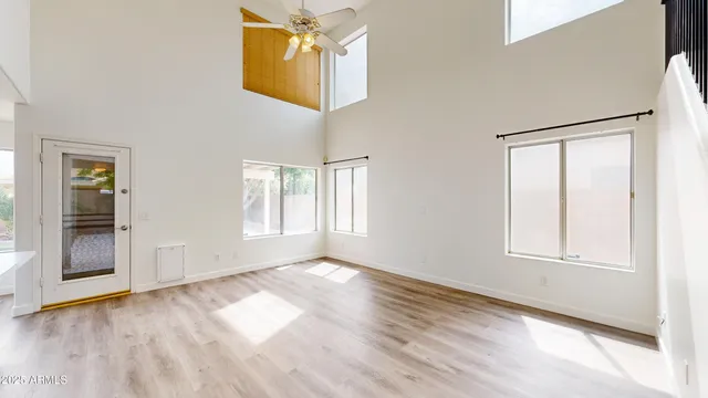 an empty room with windows and cabinet