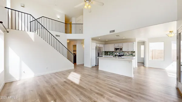 a view of open kitchen with wooden floor and electronic appliances