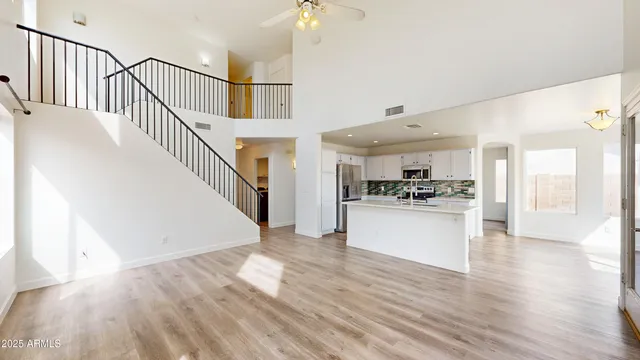 a view of open kitchen with wooden floor and electronic appliances