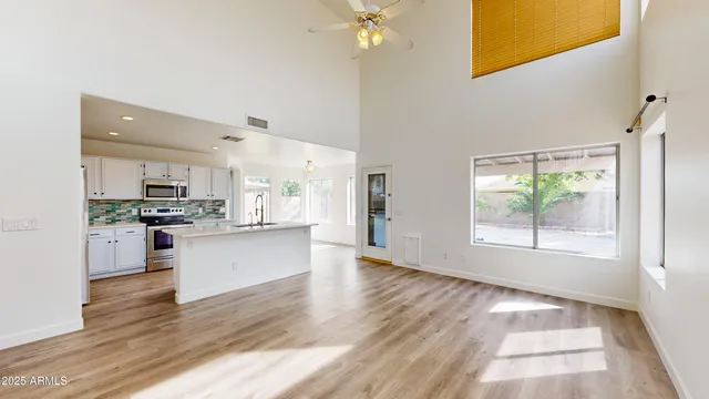 a kitchen with a refrigerator and white cabinets