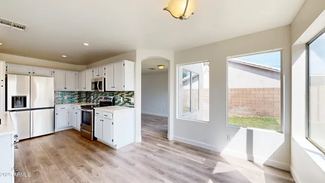 a kitchen with a refrigerator and a stove top oven