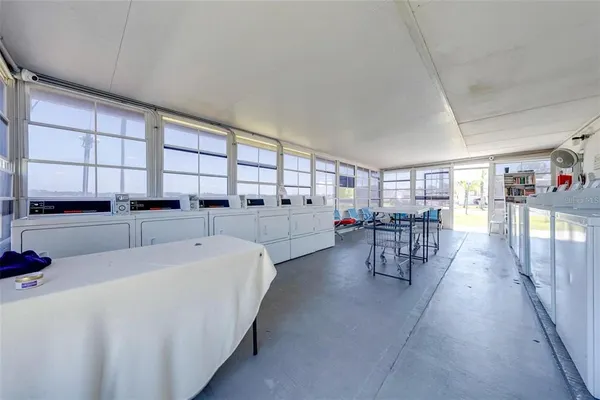a living room with furniture and view of kitchen