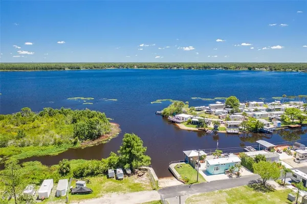 a view of a lake with a table and a chairs