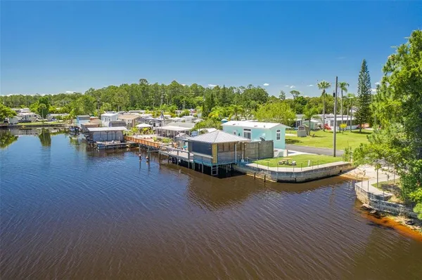 a view of swimming pool with outdoor seating and plants