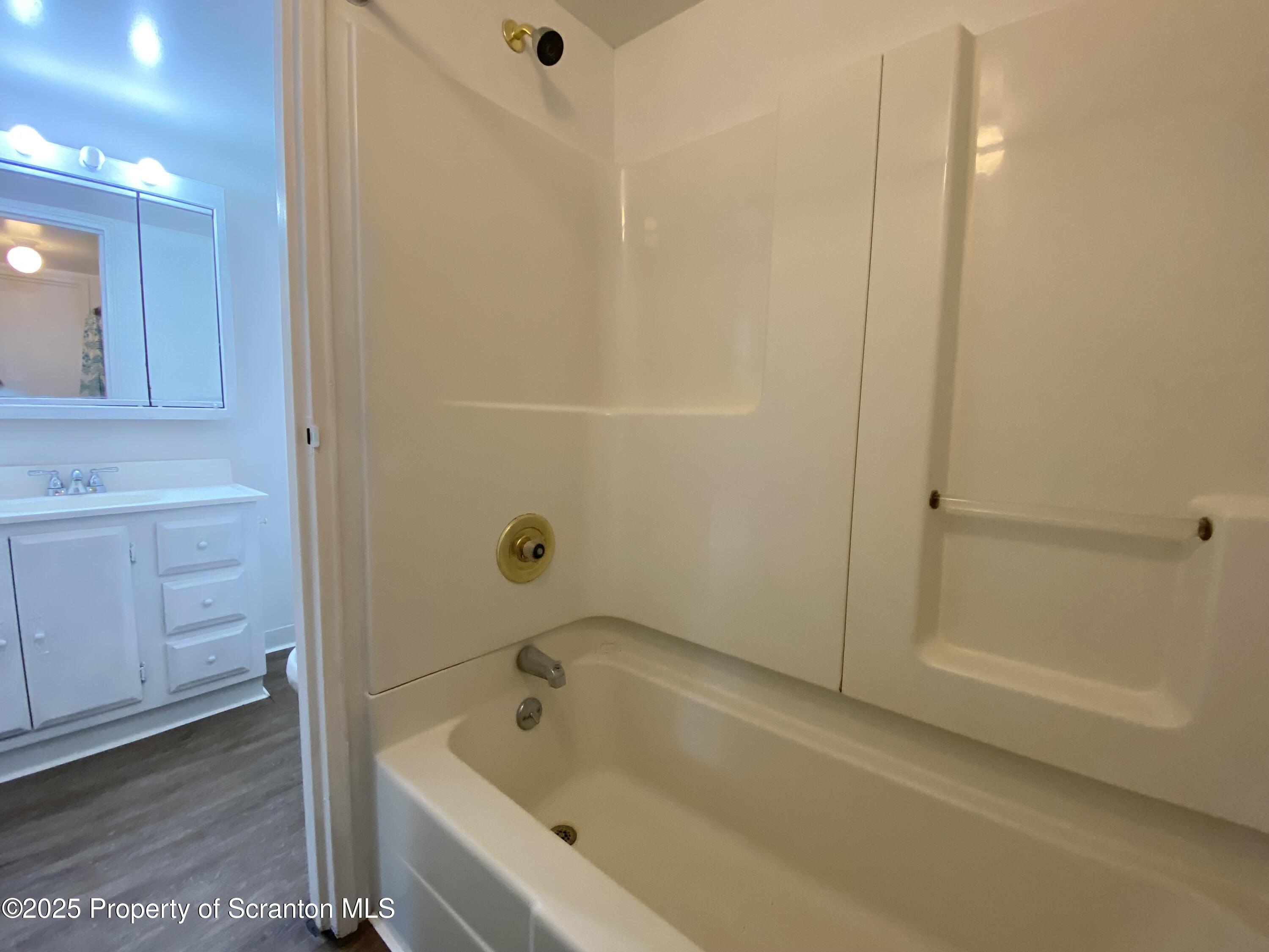 1309 Summit Pointe Scranton, PA 18508 - Photo 17 of 33 a bathroom with a tub shower vanity and a sink