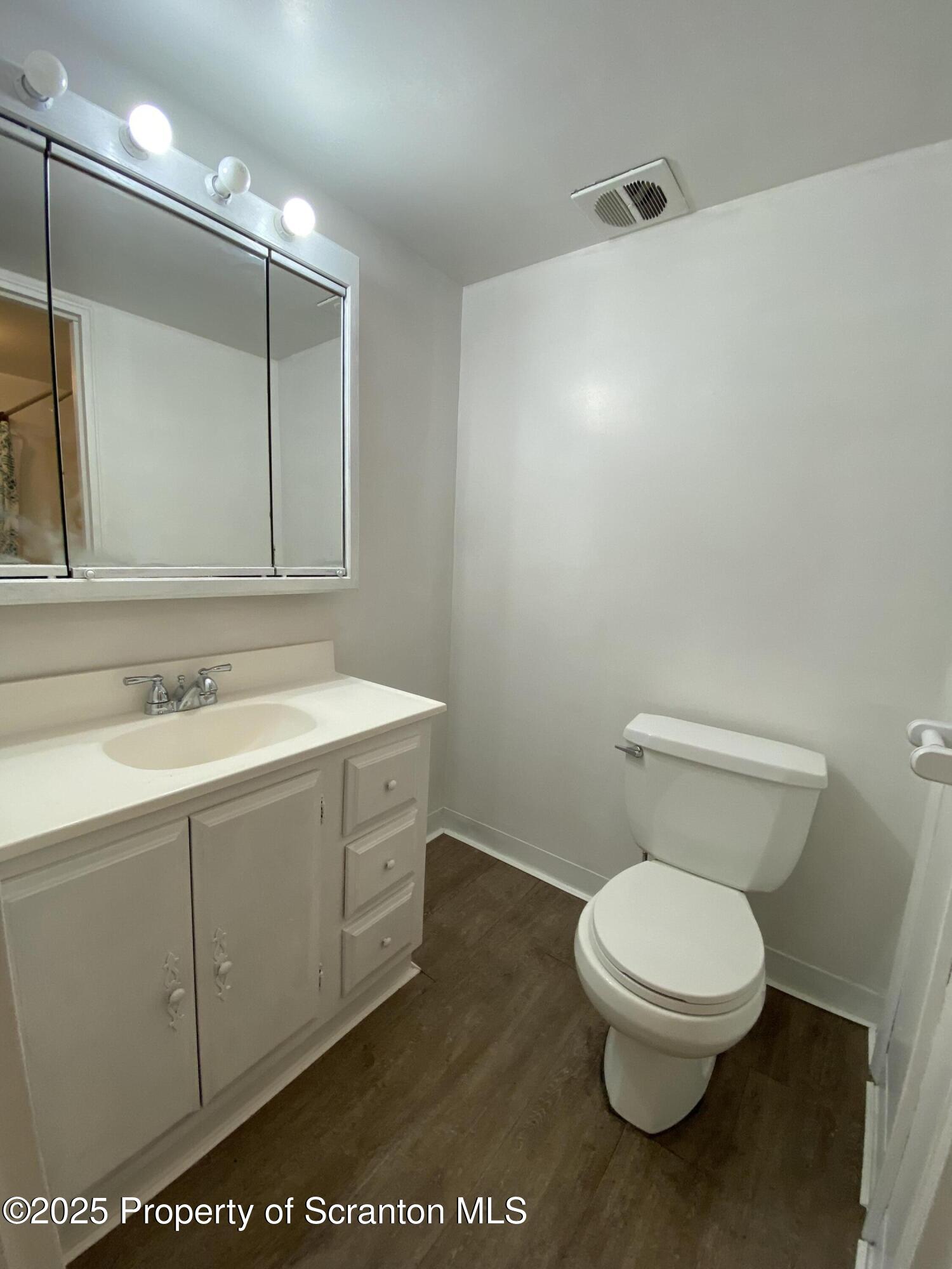 1309 Summit Pointe Scranton, PA 18508 - Photo 19 of 33 a bathroom with a toilet sink and mirror