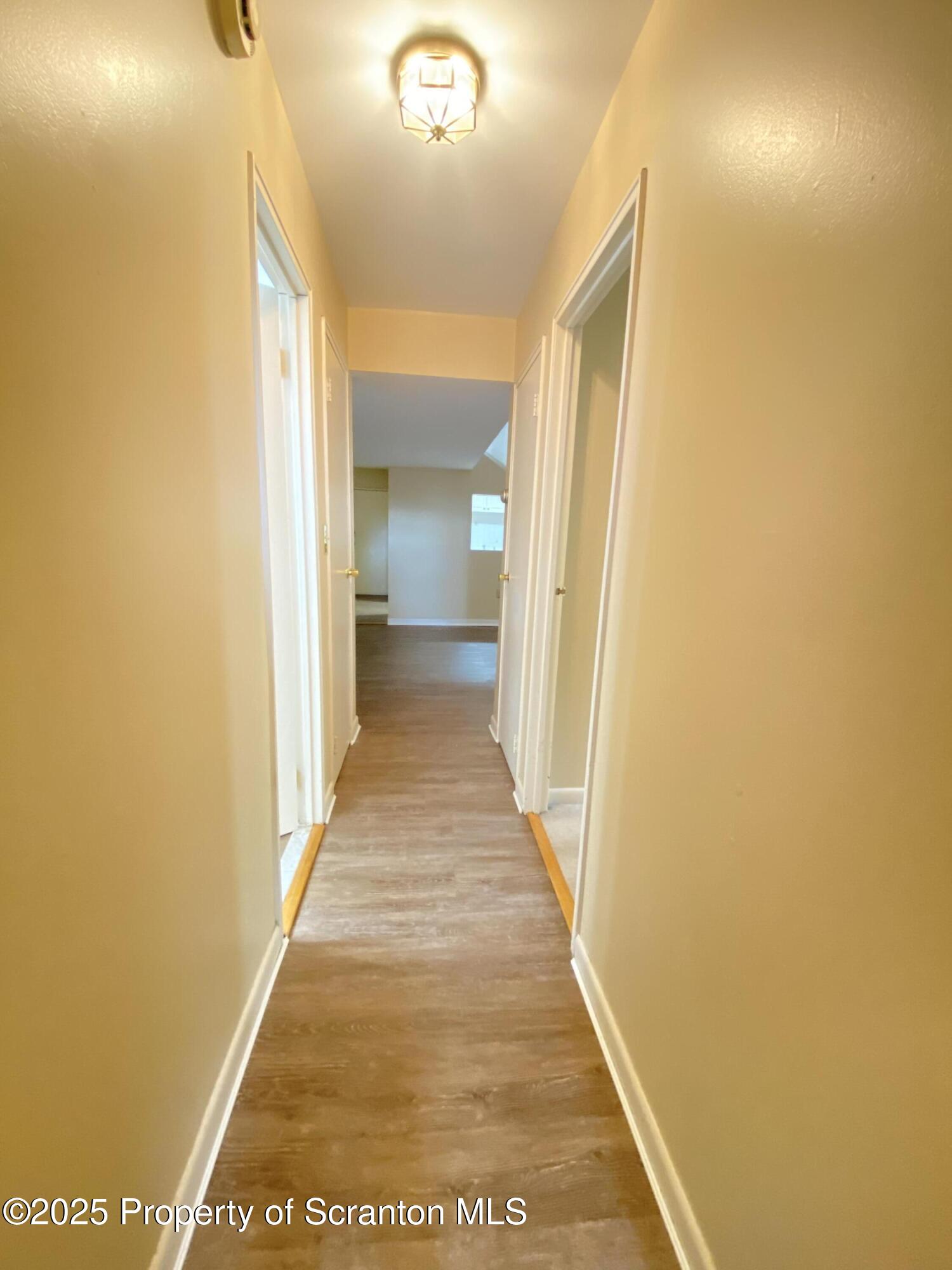 1309 Summit Pointe Scranton, PA 18508 - Photo 24 of 33 a view of a hallway with wooden floor