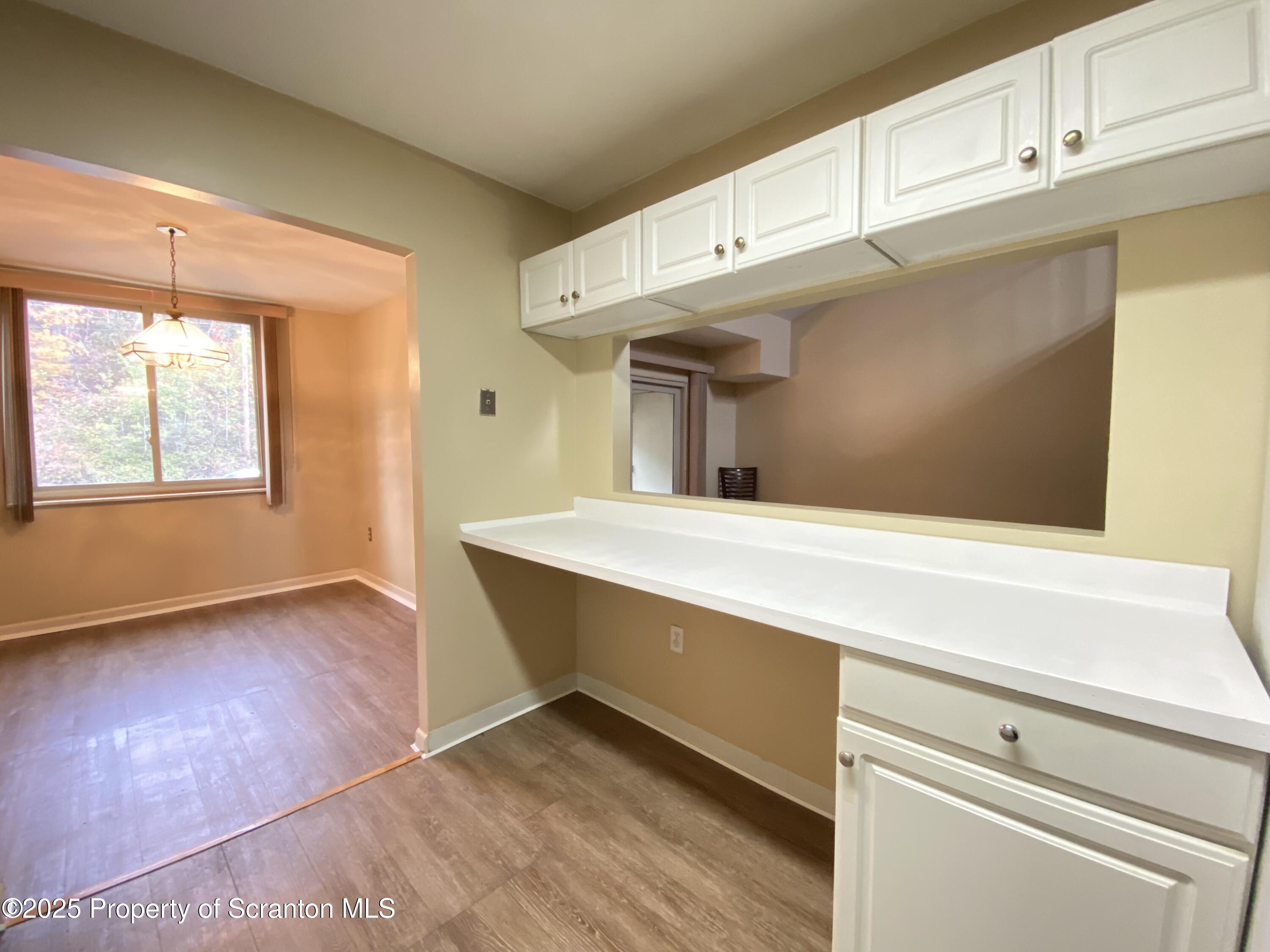 1309 Summit Pointe Scranton, PA 18508 - Photo 7 of 33 a view of an empty room with wooden floor and a window