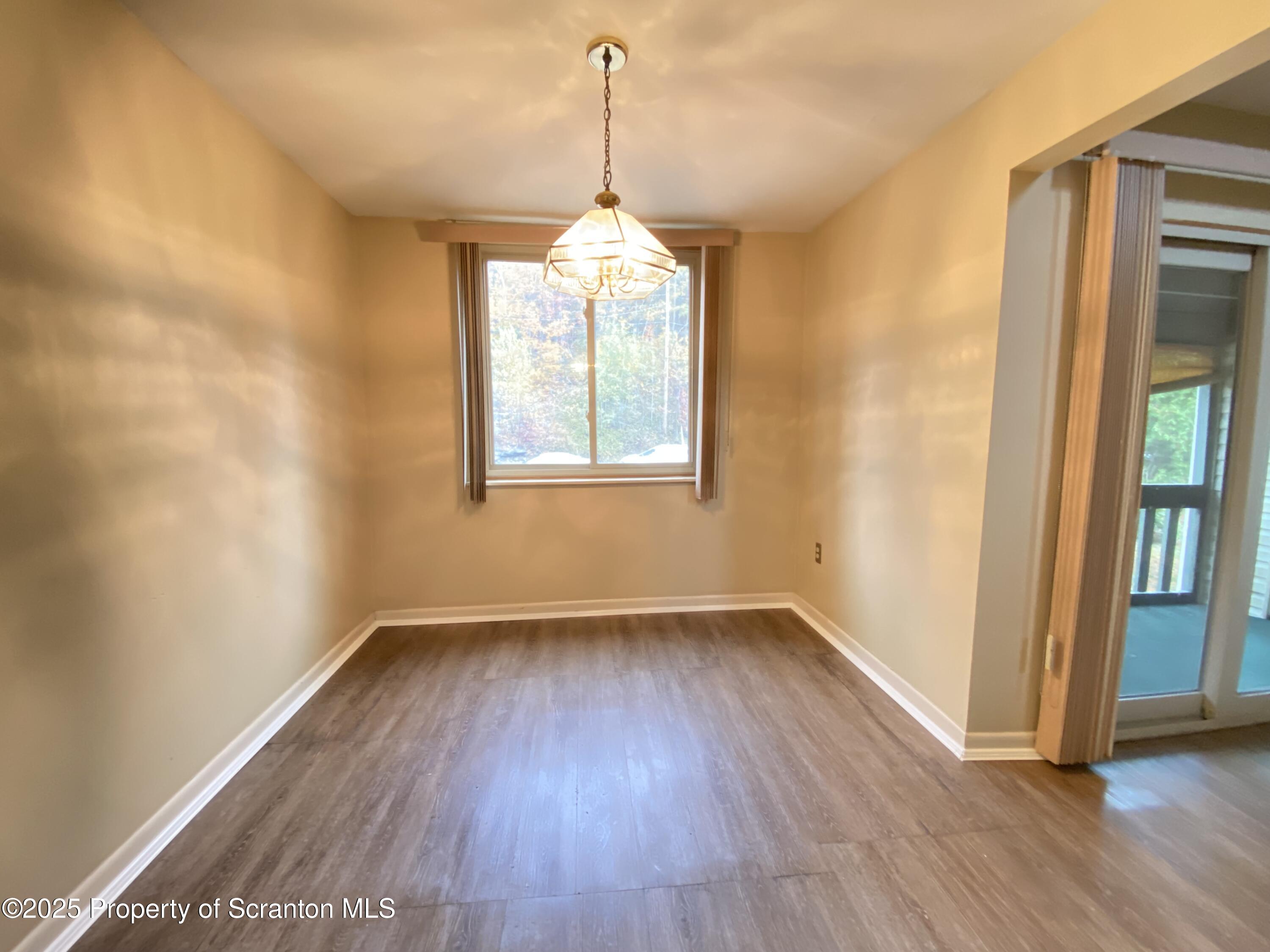 1309 Summit Pointe Scranton, PA 18508 - Photo 8 of 33 an empty room with wooden floor and windows