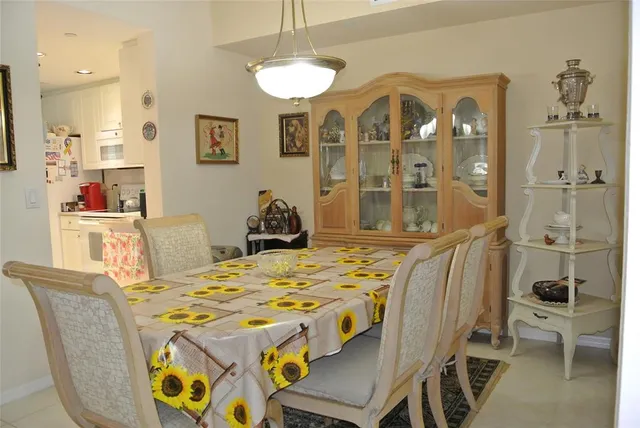 a view of a dining room with furniture and a chandelier