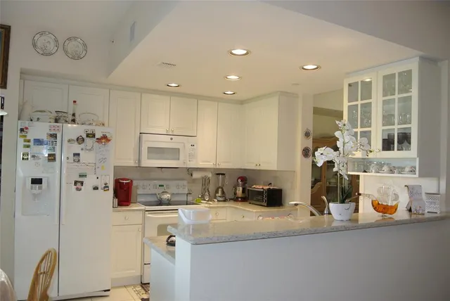 a kitchen with stainless steel appliances granite countertop a sink and cabinets