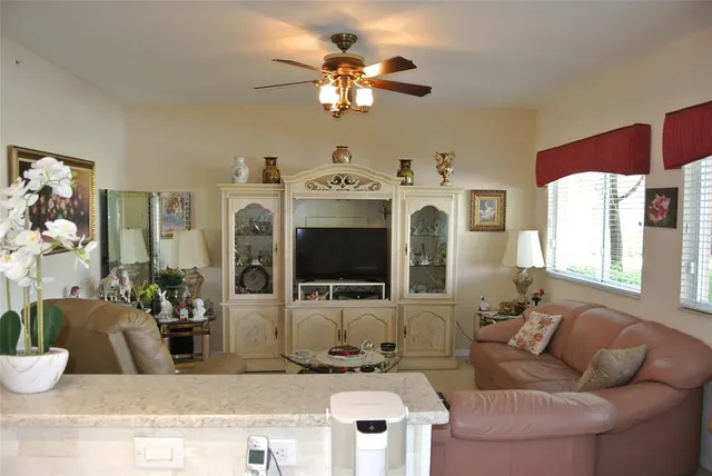 a living room with furniture chandelier and a large window