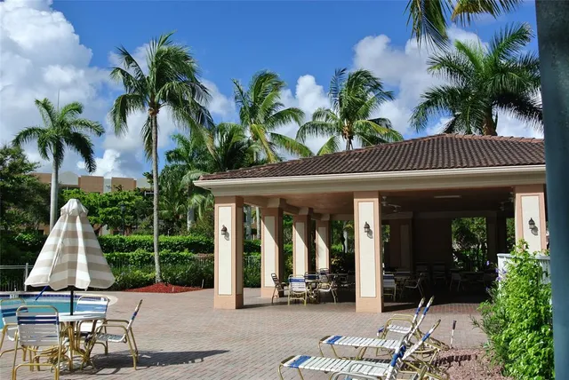 a view of a chair and tables in patio of the house