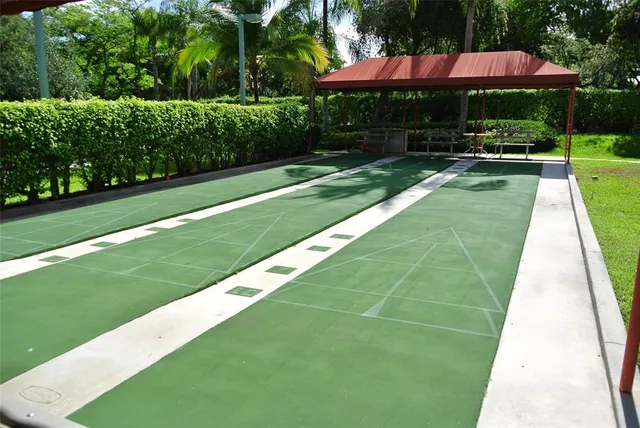 a view of a backyard with a patio and garden