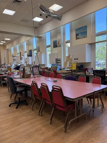 a dining room with a wooden table and chairs
