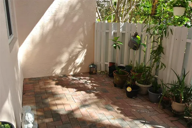 a view of a backyard with plants and trees