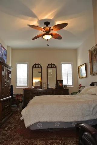 a bedroom with a large bed and a chandelier