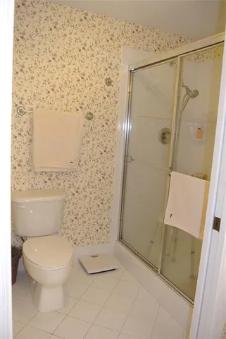 a white toilet sitting next to a shower curtain