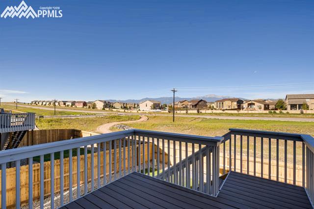 6118 Jorie Road Colorado Springs, CO 80927 - Photo 11 of 11 Welcome out to your composite deck, fully landscaped back yard with 6 foot privacy fence. Basement walks out on to a 10x10 concrete pad just at the bottom of the stairs in photo.