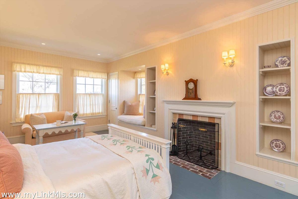 25 Lelands Path Edgartown, MA 02539 - Photo 26 of 56 a spacious bedroom with a bed and a fireplace