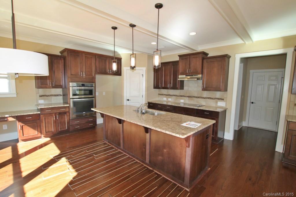 2207 Bluebell Way, Unit 14 Fort Mill, SC 29708 - Photo 6 of 20 a kitchen with stainless steel appliances granite countertop a sink a stove and a refrigerator