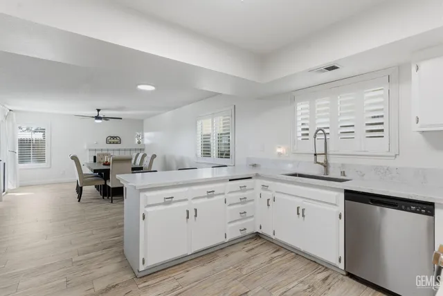 a kitchen with a sink cabinets and wooden floor