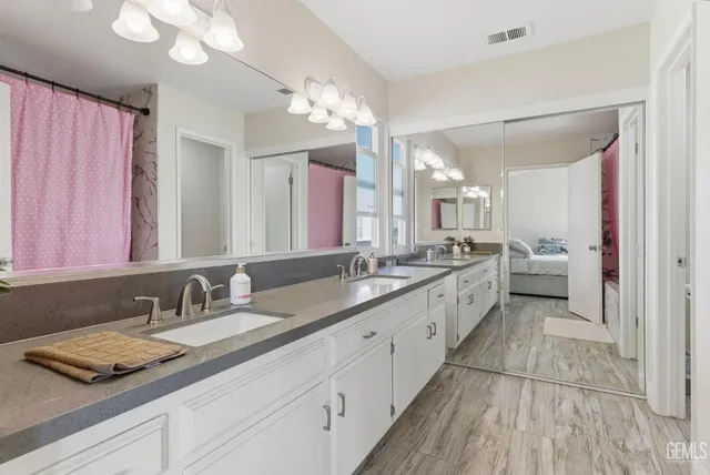 a spacious bathroom with a granite countertop sink a mirror and a