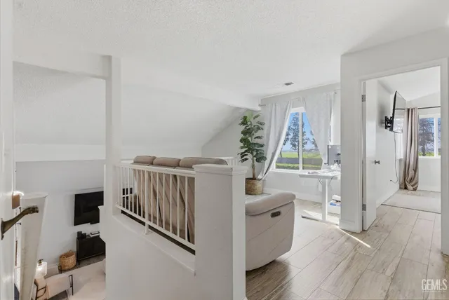 a view of a livingroom with furniture and hardwood floor