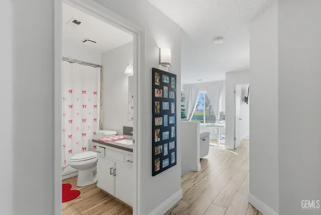 a room with a wooden floor and white walls