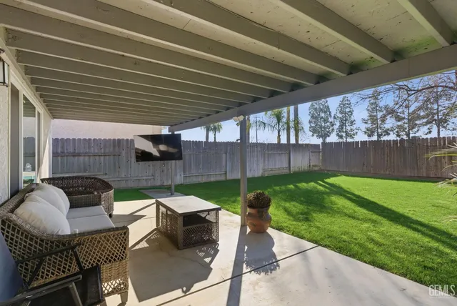 a patio with wooden table and chairs