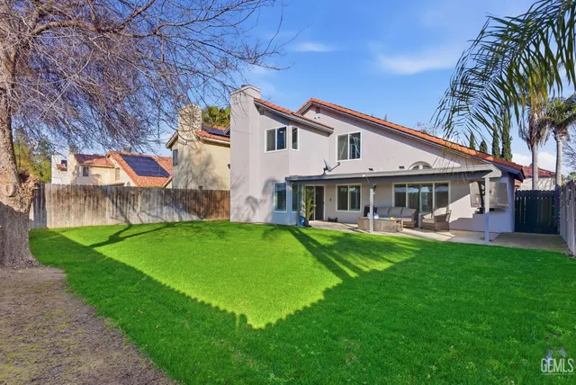 a front view of house with yard and outdoor seating