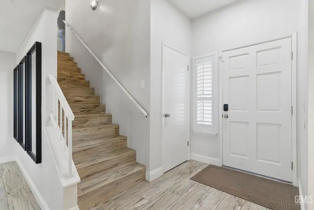 a view of entryway with wooden floor and stairs