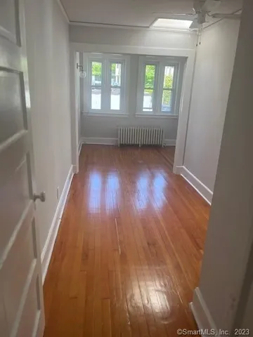 wooden floor in an empty room with a window