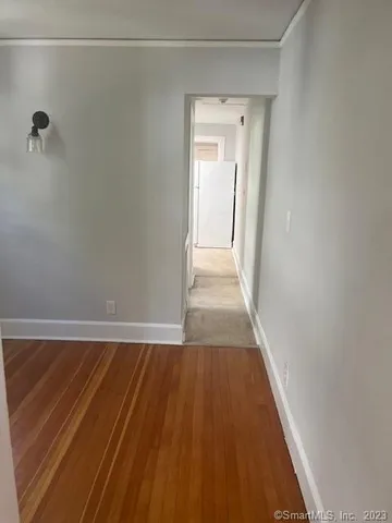 a view of a room with wooden floor and cabinet