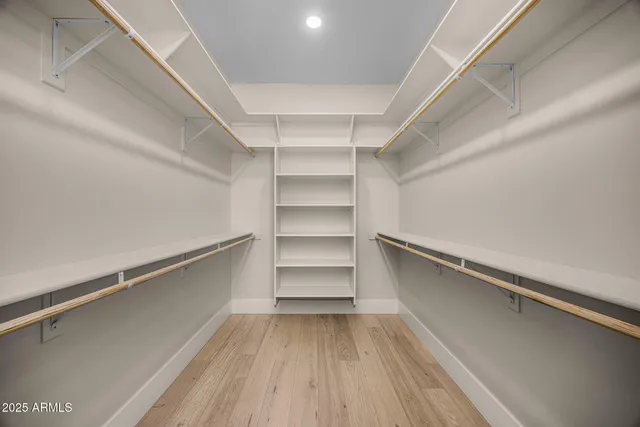 a view of walk in closet with empty racks