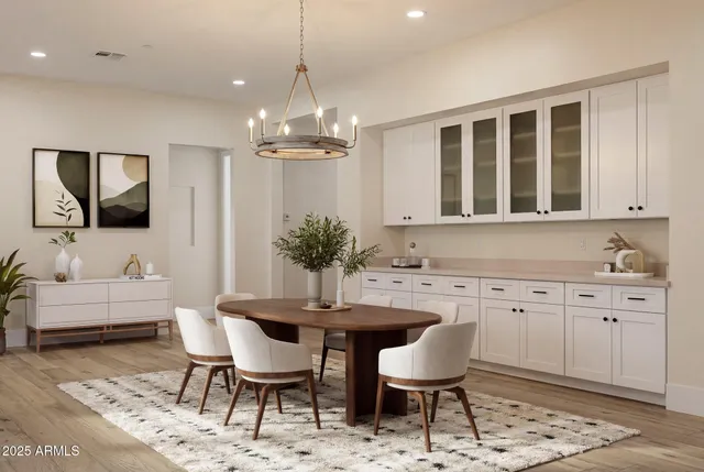a view of a kitchen area with furniture and wooden floor