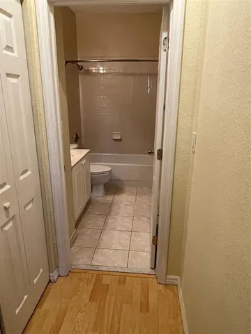 a bathroom with a tub shower vanity and a sink