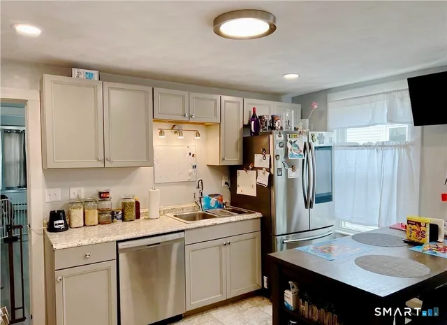 a kitchen with refrigerator and sink
