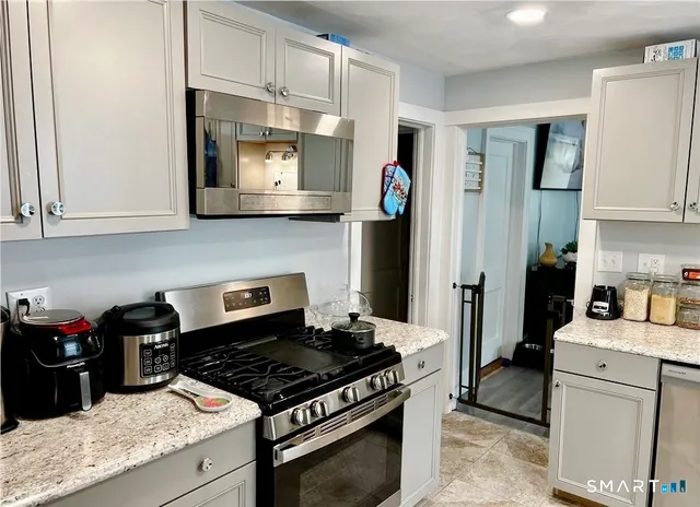 a kitchen with stainless steel appliances granite countertop a stove and a refrigerator