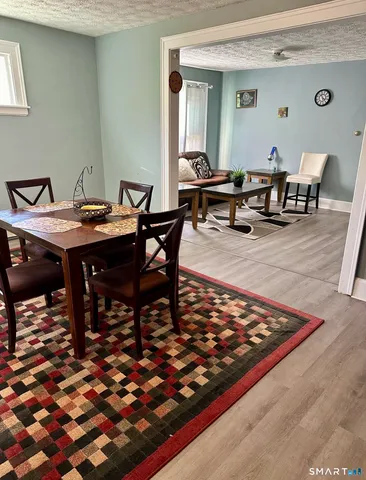 a outdoor dining space with furniture and rug