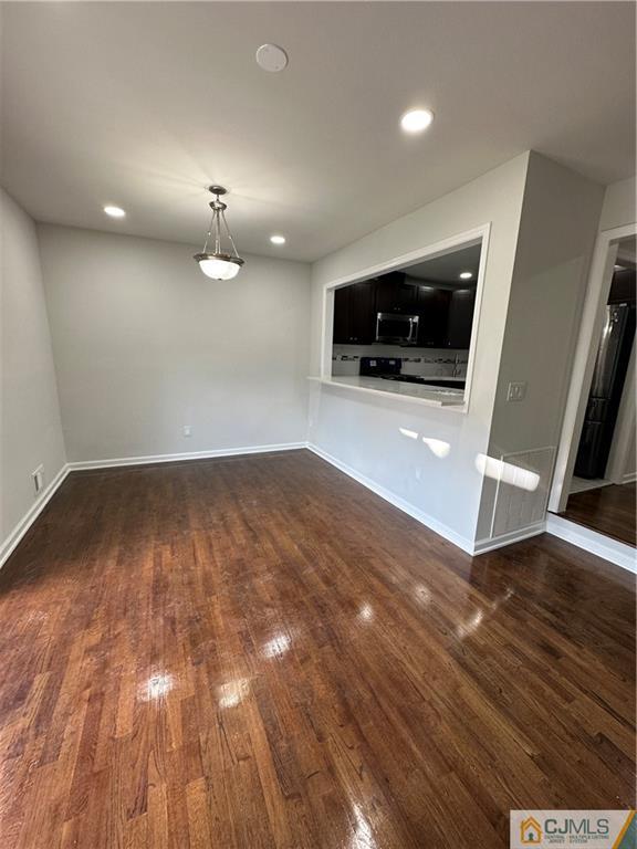 3605 Hana Road Edison, NJ 08817 - Photo 11 of 25 an empty room with wooden floor and kitchen