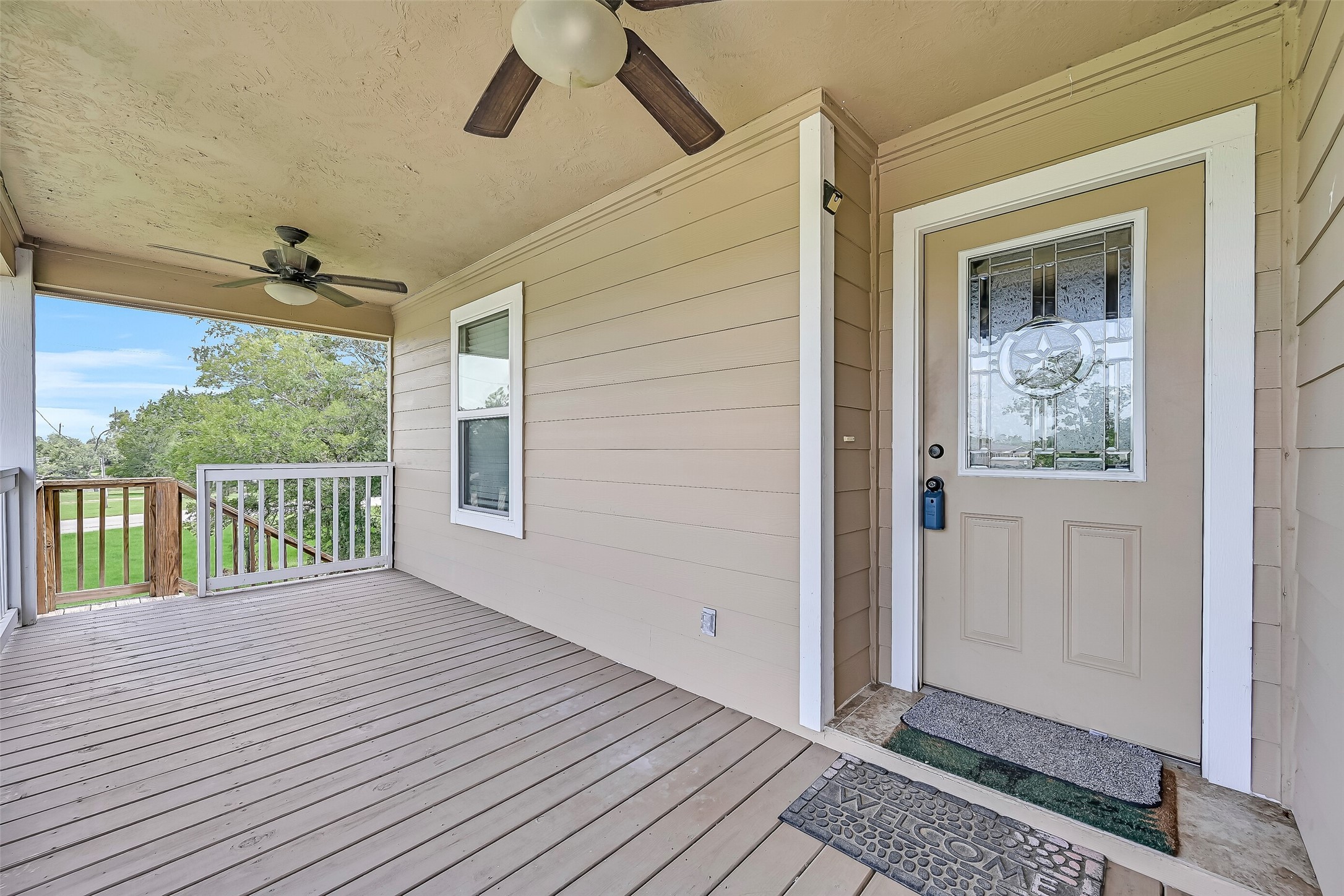 11930 Bastrop Beach Road Angleton, TX 77515 - Photo 11 of 29 A welcoming covered porch sets the tone before you even step inside, offering a comfortable place to relax while the decorative front door adds a touch of character to this custom-built home.